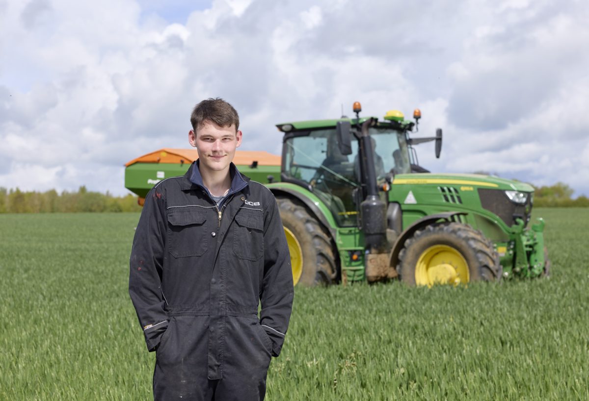 farm student standing in front of tractor