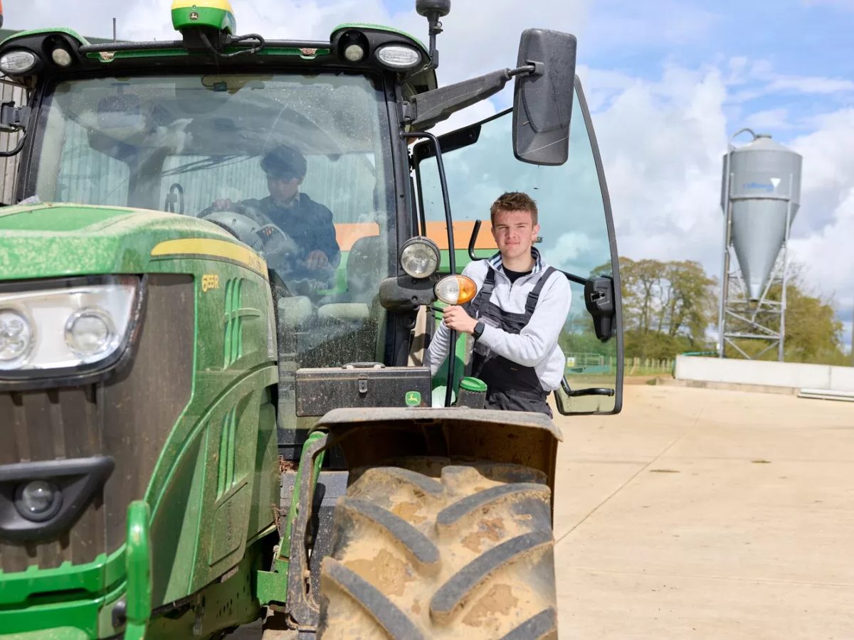 Agriculture Student standing in door of tractor