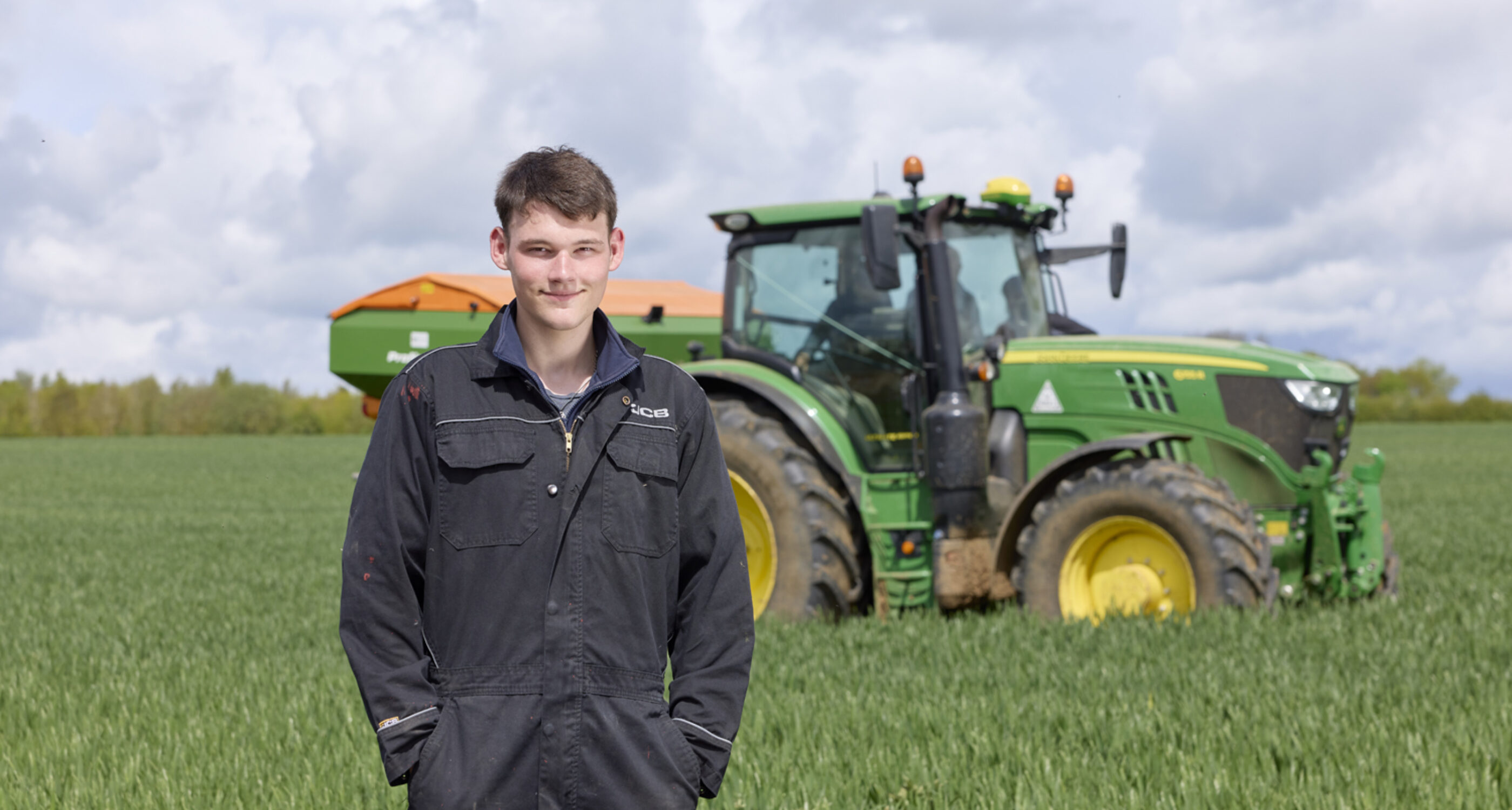 farm student standing in front of tractor