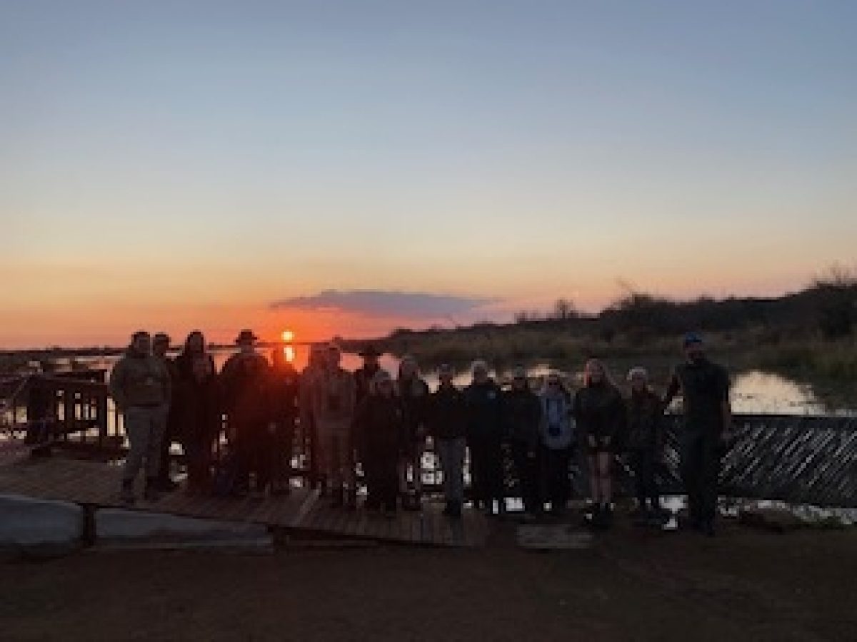 Tour group in front of sunset in South Africa