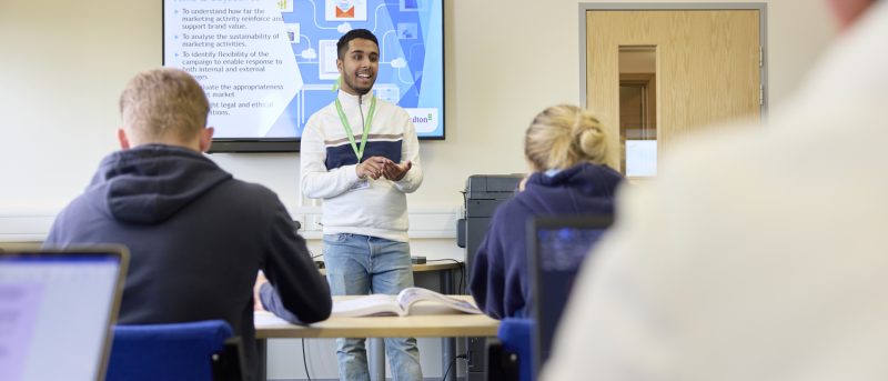 Business student giving presentation in front of class