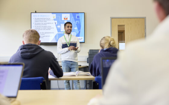 Business student giving presentation in front of class