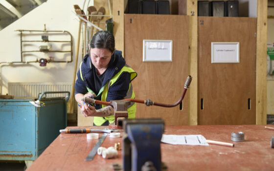 Plumbing student working on a pipe