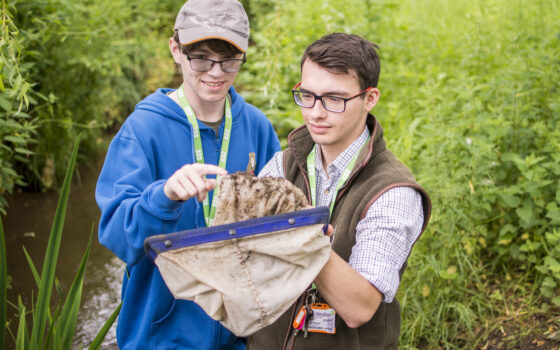 Two students stood in a stream