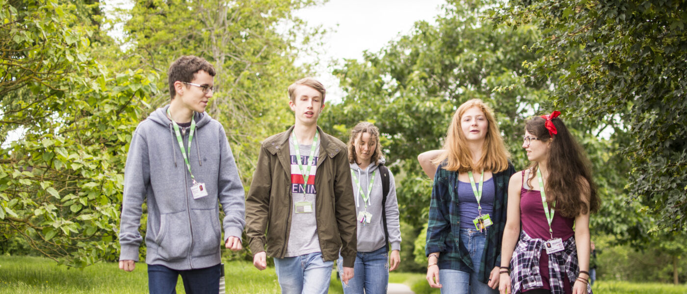 Students walking through arboretum 212