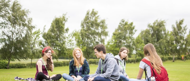 Group of Students sitting on the grass