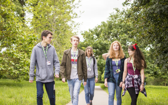 Students walking through arboretum 212