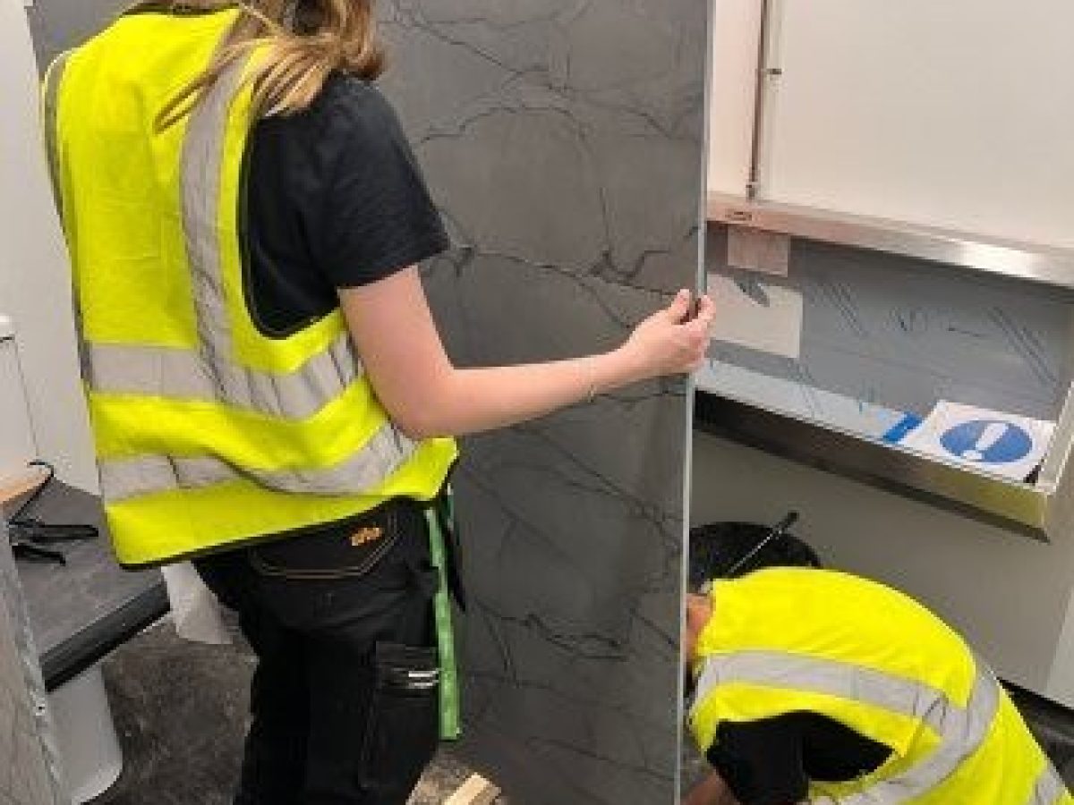 Students fitting cubicles during work experience placement