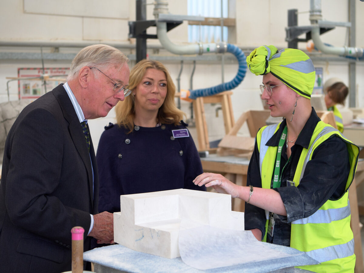 HRH The Duke of Gloucester speaking to stonemasonry student Holly