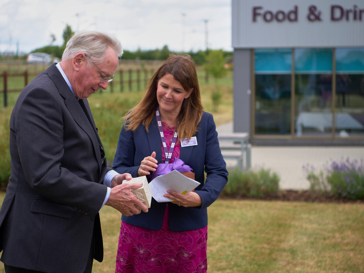 Principal & CEO Corrie Harris presents HRH The Duke of Gloucester with stone paperweight by stonemasonry student, Louise Regan