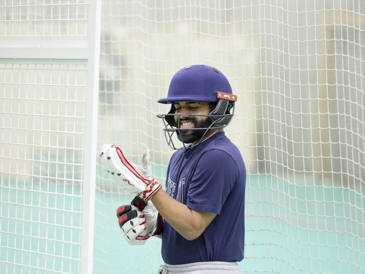 Student smiling with equipment on