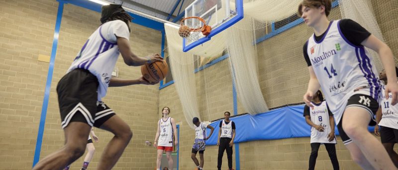 Sports students playing basketball