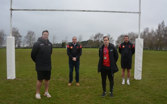 Staff in front of goal post