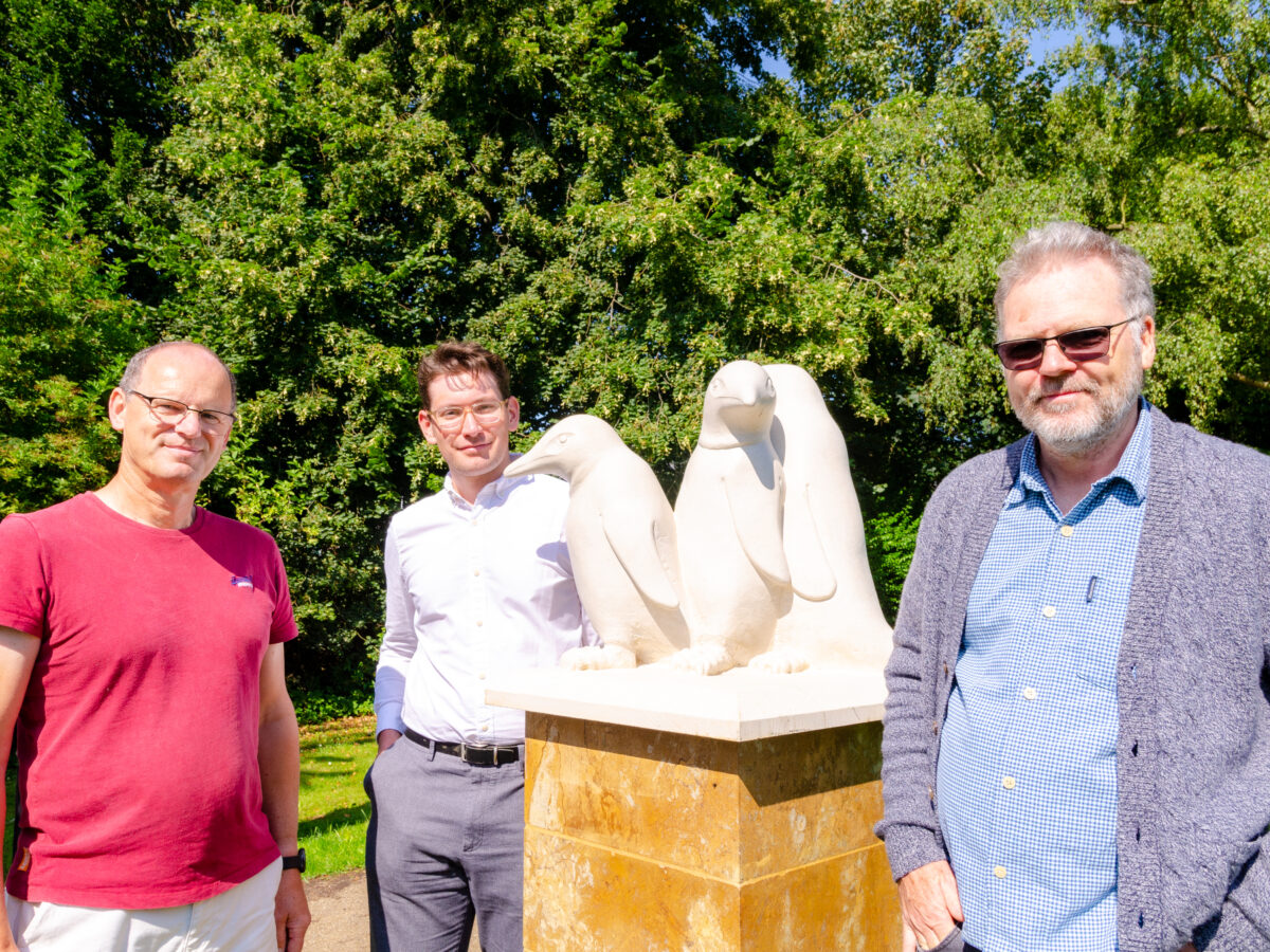 Students and staff with the penguins sculpture