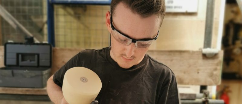 John chiseling block of stone