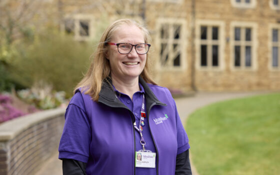 Careers Advisor smiling wearing a purple moulton polo and vest